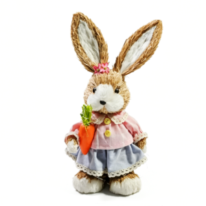 Handmade sisal Easter bunny figurine in pink and blue outfit holding a carrot